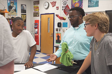 一位非裔美国助教带领着一群混合学生