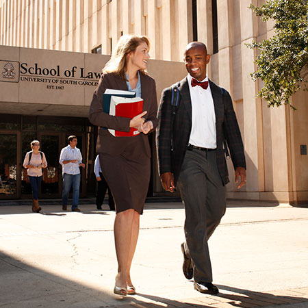 一名白人女学生和一名黑人男学生在走出南卡罗来纳法学院以前的建筑时交谈。